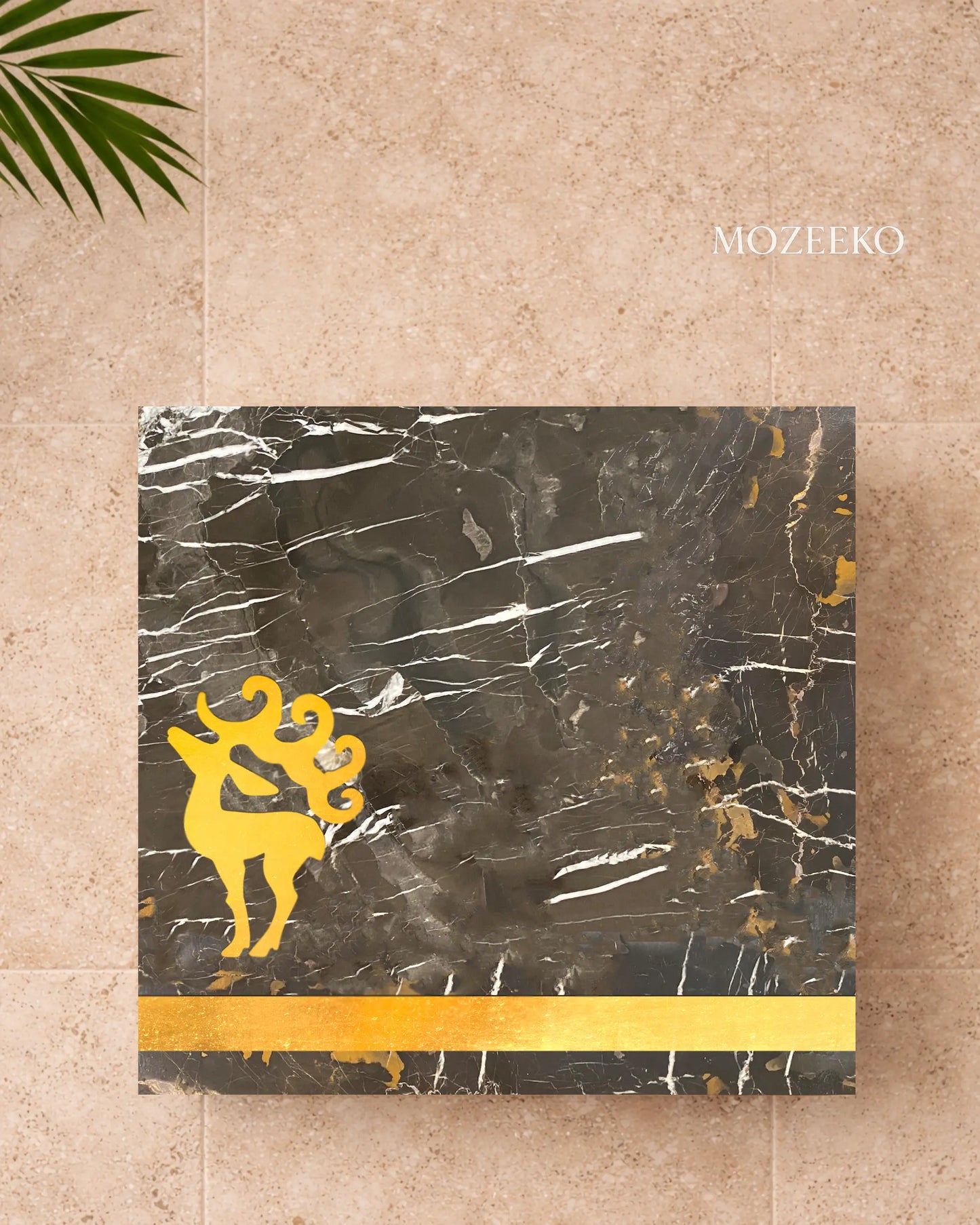 Black and gold marble table top with brass stag emblem and wide brass border