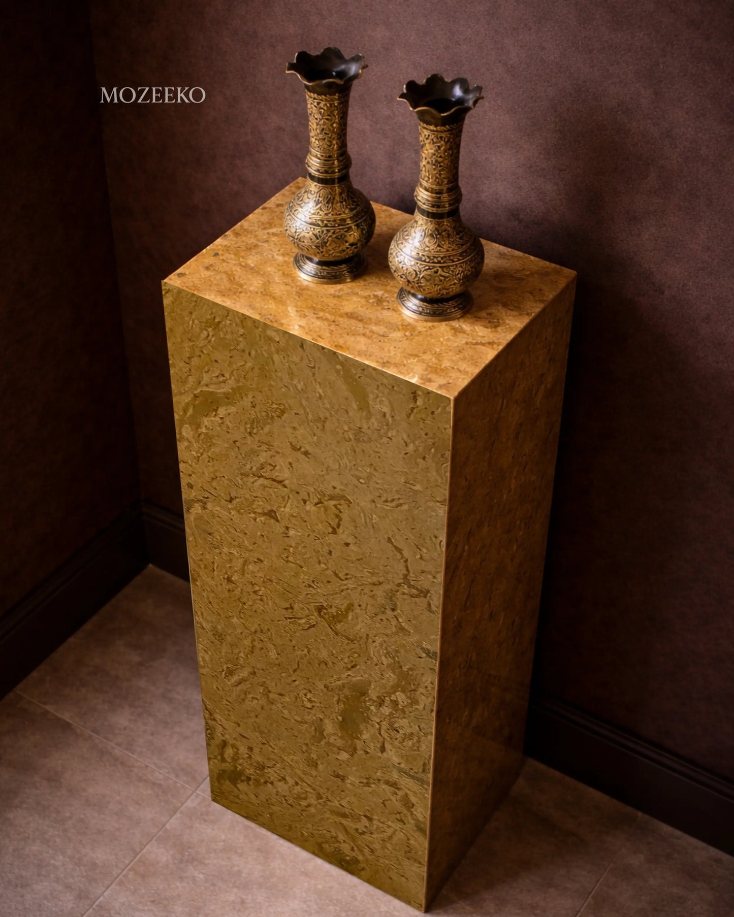Side view of Desert Gold marble plinth highlighting hollow mitered construction and natural stone veining