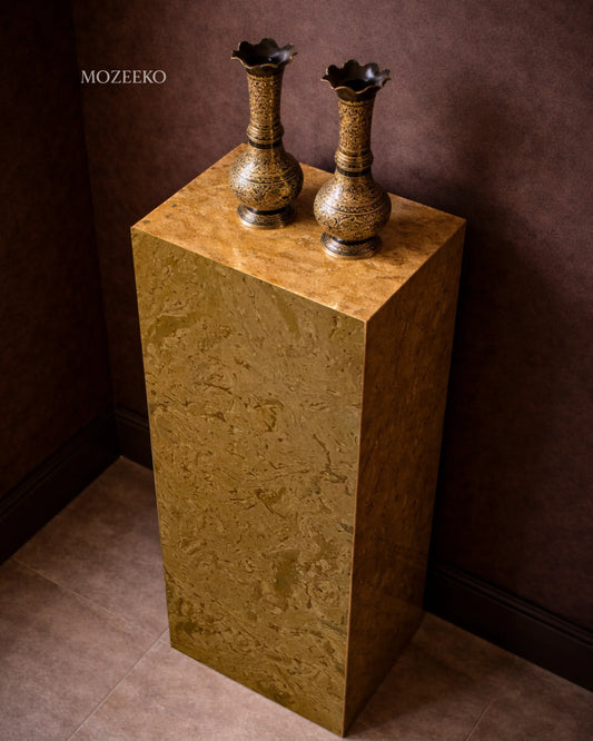 Side view of Desert Gold marble plinth highlighting hollow mitered construction and natural stone veining