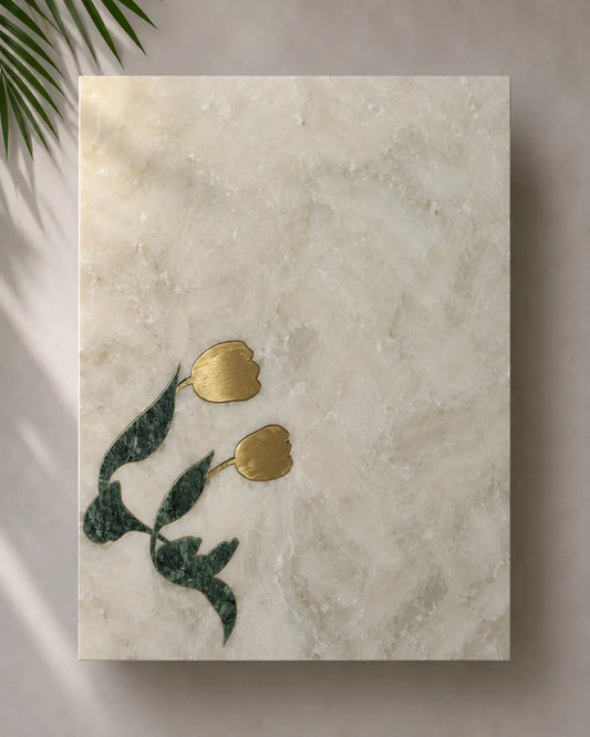 Decorative tmarle with gold tulips and green leaves on a white marble background