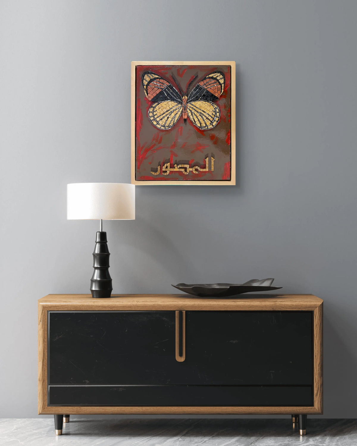Handmade marble mosaic artwork featuring a butterfly motif and Arabic calligraphy Al-Muṣawwir over an abstract acrylic painted background, framed in a golden floating wooden frame by Mozeeko Atelier.1