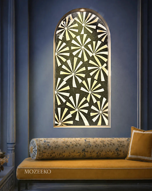 Black and beige starburst marble mosaic wall art displayed in a tall arched niche above a sofa.