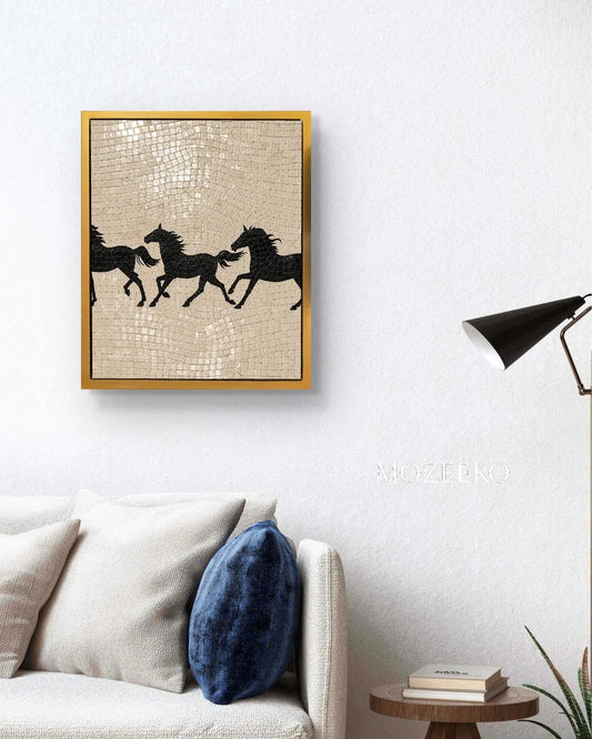 : Black running horses marble mosaic wall art displayed in a golden frame above a white sofa.