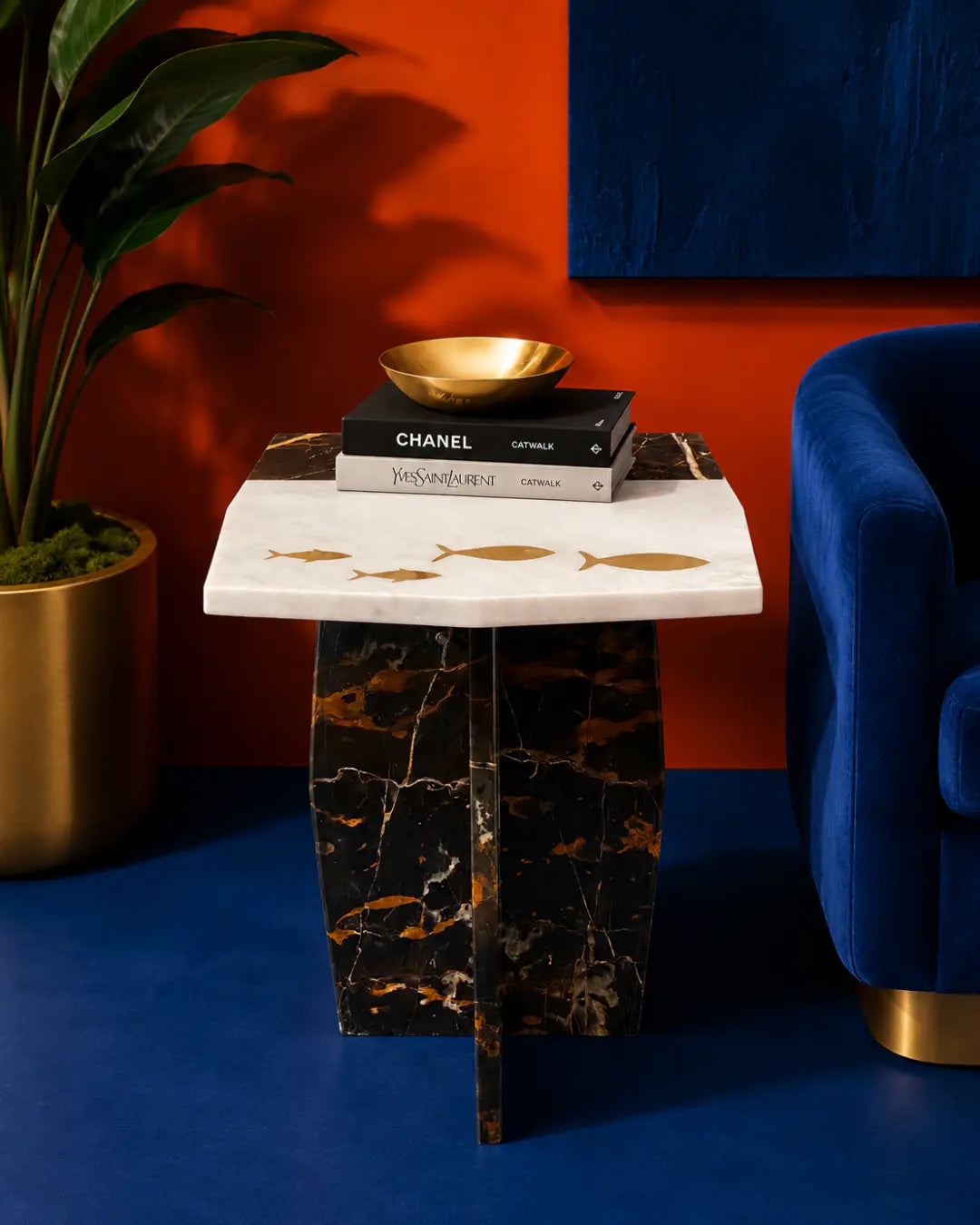 Marble table with gold fish designs on a beige background