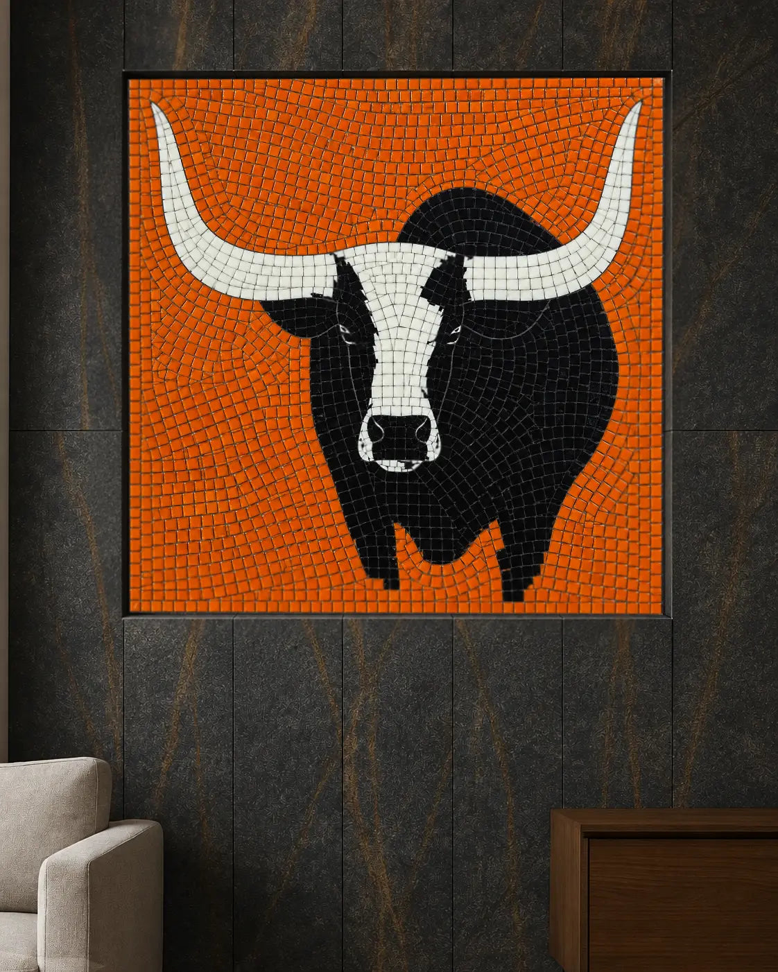 Black and white bull on an orange vitreous glass mosaic panel installed in a dark interior feature wall.