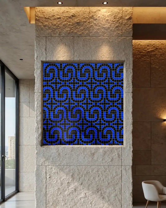 Black and deep-blue geometric vitreous glass mosaic installed in a recessed stone feature wall.