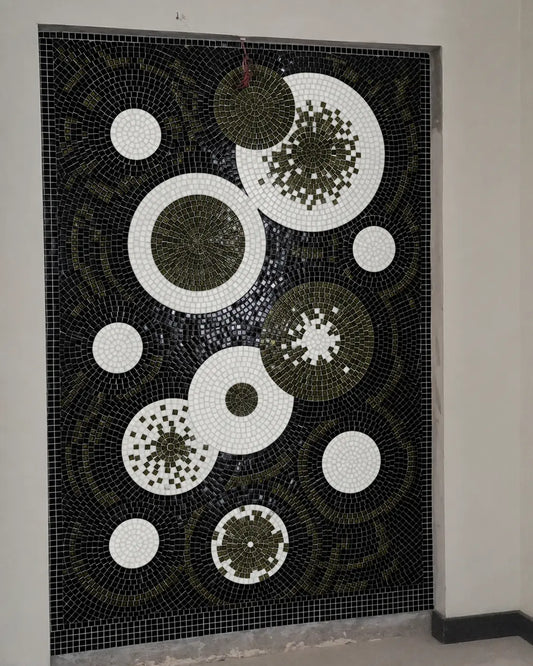 Abstract black, white and dark-olive circular vitreous glass mosaic installed in a recessed wall niche.