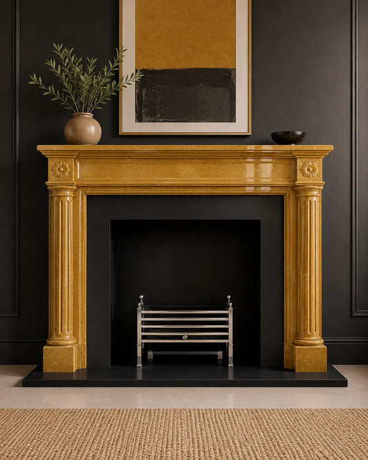 Handcrafted golden marble fireplace surround with fluted columns, carved rosettes, and polished natural stone finish.