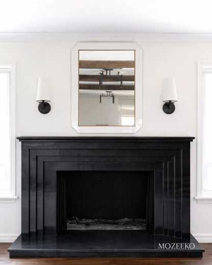 Minimalist jet black granite fireplace with stepped architectural profiles, handcrafted as a modern luxury fireplace by Mozeeko.2