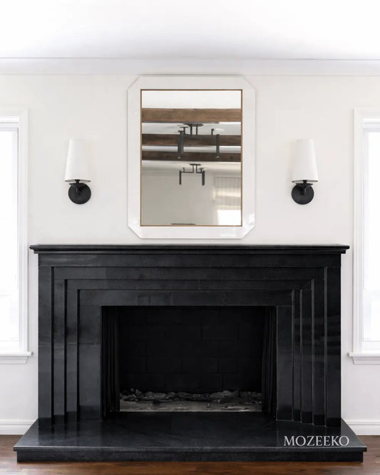 Minimalist jet black granite fireplace with stepped architectural profiles, handcrafted as a modern luxury fireplace by Mozeeko.2