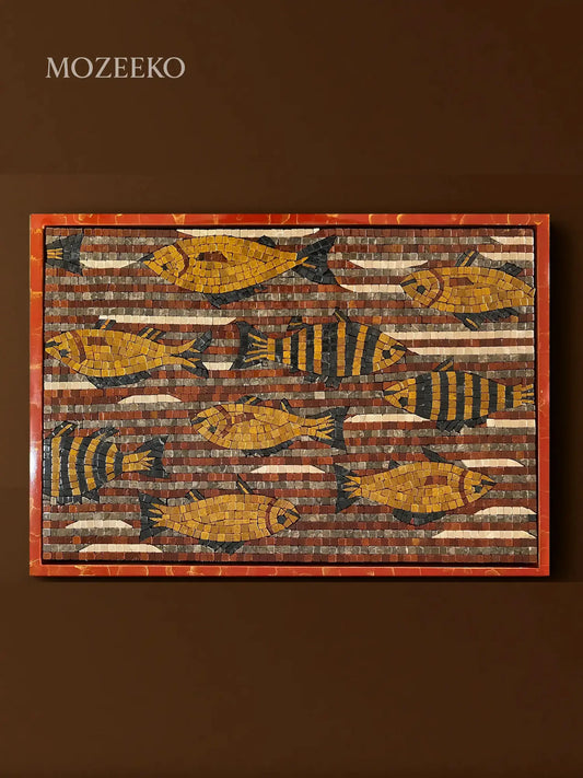 Close-up of hand-cut golden marble fish forming a flowing shoal pattern in mosaic art