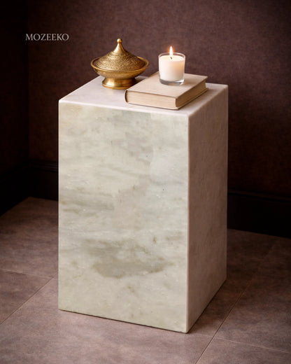 Side view of Kamoor white marble plinth highlighting hollow mitered construction and soft stone texture