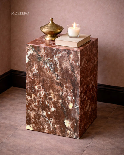 Side view of strawberry marble plinth highlighting hollow mitered construction and expressive stone veining