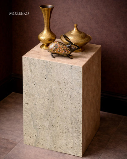 Travertine marble plinth with mitered corners and architectural form, shown as a sculptural accent pedestal-brass
