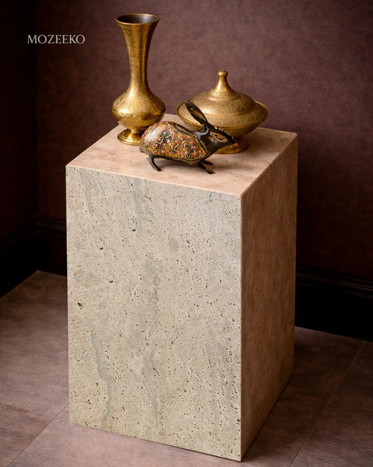Travertine marble plinth with mitered corners and architectural form, shown as a sculptural accent pedestal-brass