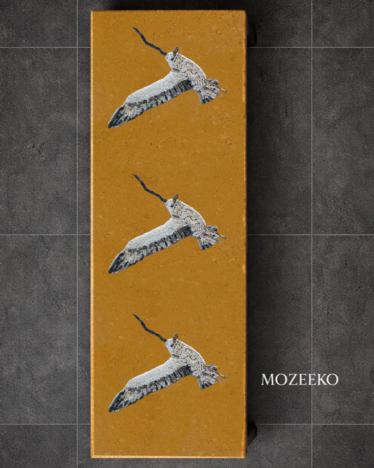 Golden marble vertical slab with hand-inlaid marble mosaic birds, custom tabletop design by Mozeeko