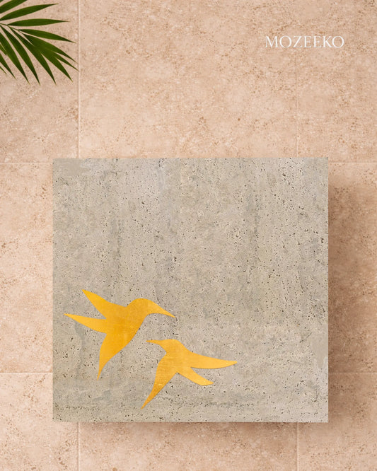 tabletops with brass birds inlaid in travertine 