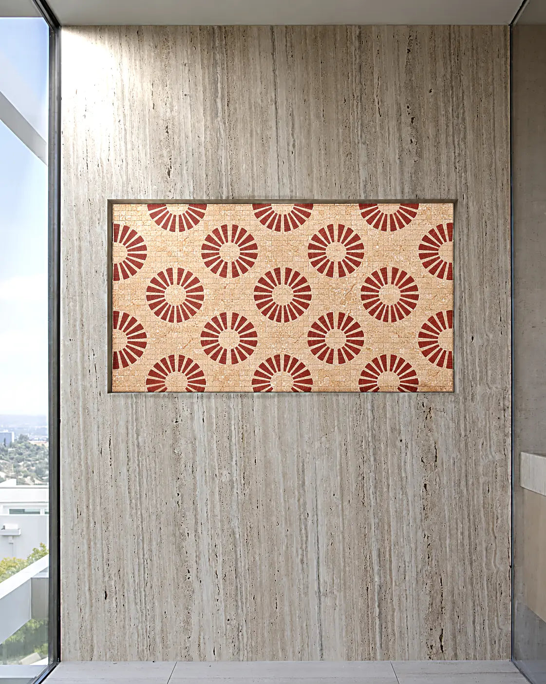 Red sunburst mosaic panel in beige travertine and natural marble installed in a contemporary travertine wall niche