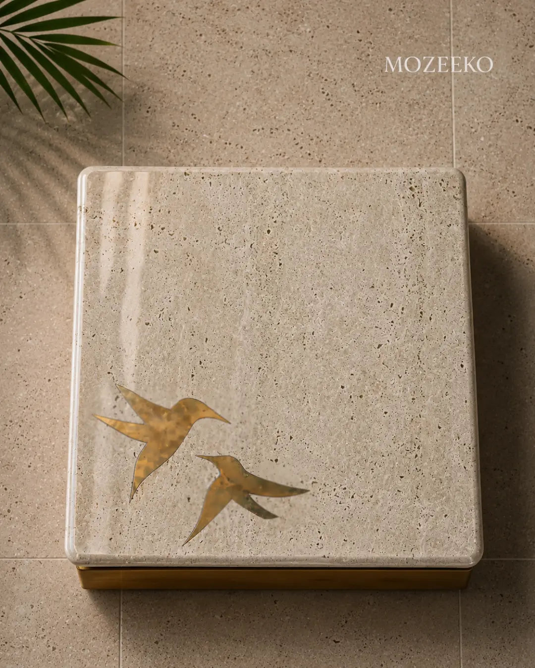 tabletops with brass birds inlaid in travertine 