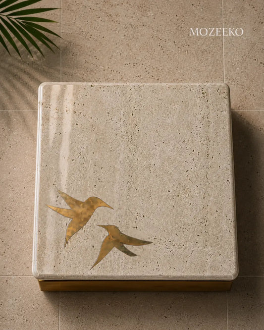 tabletops with brass birds inlaid in travertine 